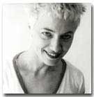 Black and white headshot of Camille Roy. Her hair is styled short and blonde. 