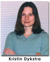 Dykstra looks at the camera in a blue shirt