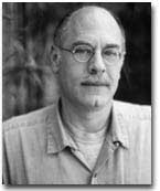 Black and white headshot of Robert Gluck. He is wearing circular glasses.