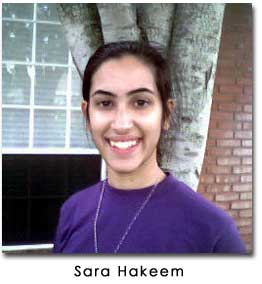 Sara Hakeem smiles at the camera wearing a purple shirt
