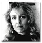 Headshot of Cynthia Hogue in black and white. Her hair is down and wavy. 