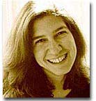 Sepia headshot of Jena Osman. She is smiling widely and her head is tilted to the right. 