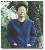 photo of Myung Mi Kim wearing a blue blazer outdoors