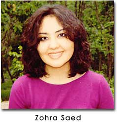 Zahra Saed wears a pink shirt and smiles at the camera