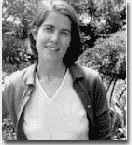 black and white photograph of Treadwell in a white v neck and jacket outside