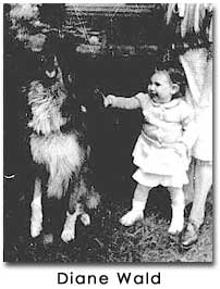 a black and white photo of a young baby girl with arm outstretched toward a large dog