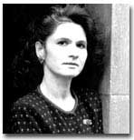 Black and white headshot of Welish. Her hair is short and she is wearing a polka dot sweatshirt.