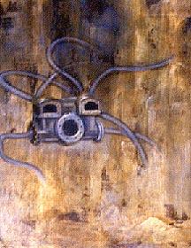 a metal object with long tentacle like appendages on a brown background